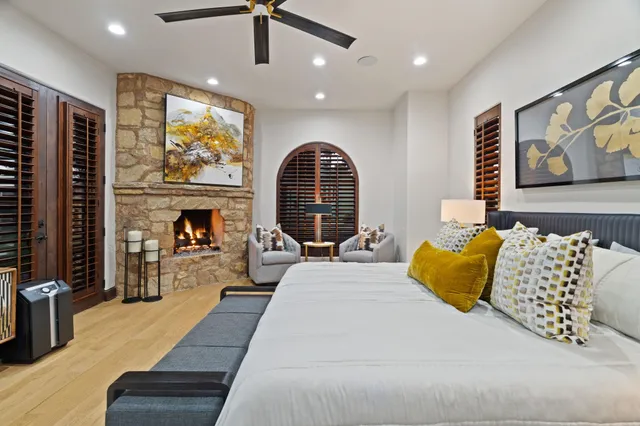 a bedroom with a bed and glass walk in closet