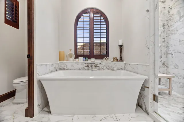 a white bath tub sitting next to a white sink