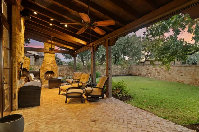 a view of a patio with table and chairs and potted plants