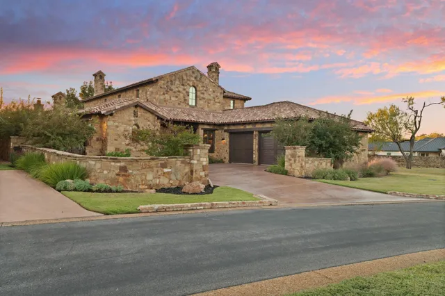 a front view of a house with a garden and yard