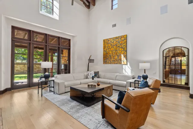 a living room with furniture and wooden floor