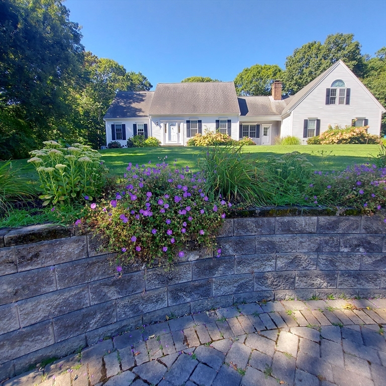 a house with lots of trees in the background