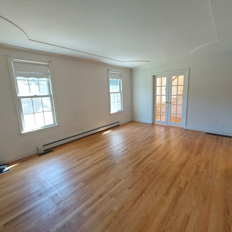 43 Barque Circle Dennis, MA 02660 - Photo 21 of 42 a view of an empty room with wooden floor and window