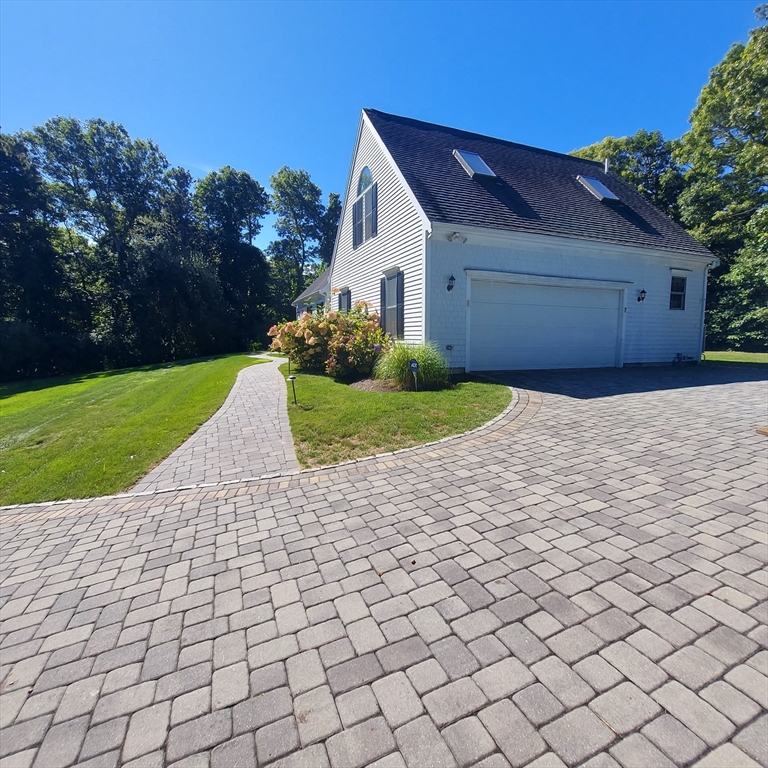 43 Barque Circle Dennis, MA 02660 - Photo 5 of 42 a front view of a house with a yard and garage