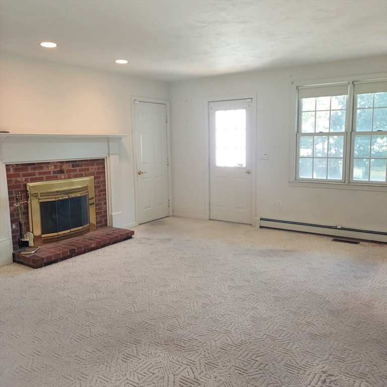 43 Barque Circle Dennis, MA 02660 - Photo 10 of 42 an empty room with windows and fireplace