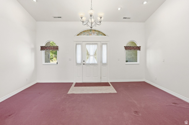 2190 750 West Perry, UT 84302 - Photo 9 of 42 Entryway featuring a double door with glass inserts, an arched transom window with stone detailing, and two arched windows
