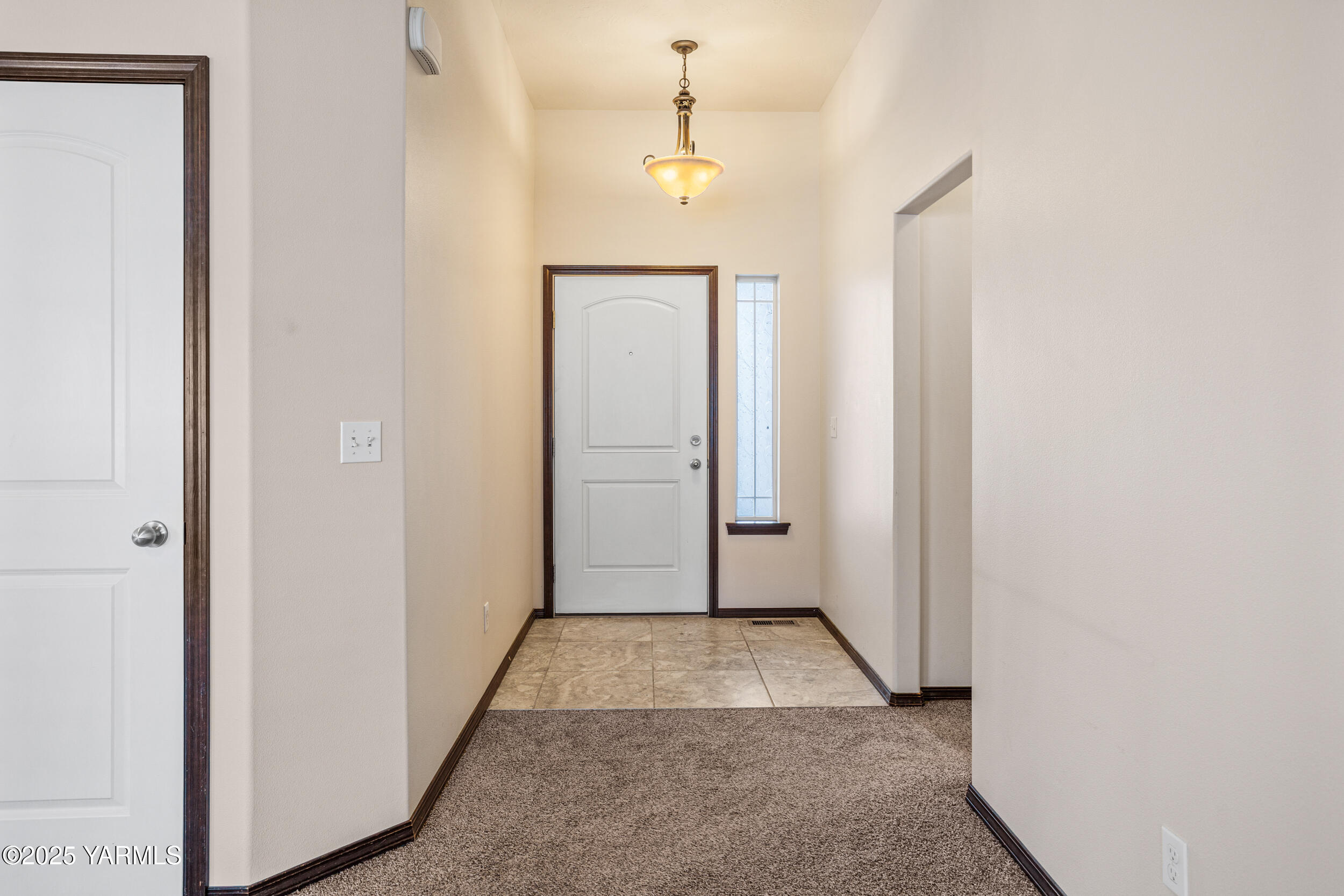 2017 South 59th Avenue Yakima, WA 98903 - Photo 5 of 32 a view of a hallway with wooden floor and a chandelier
