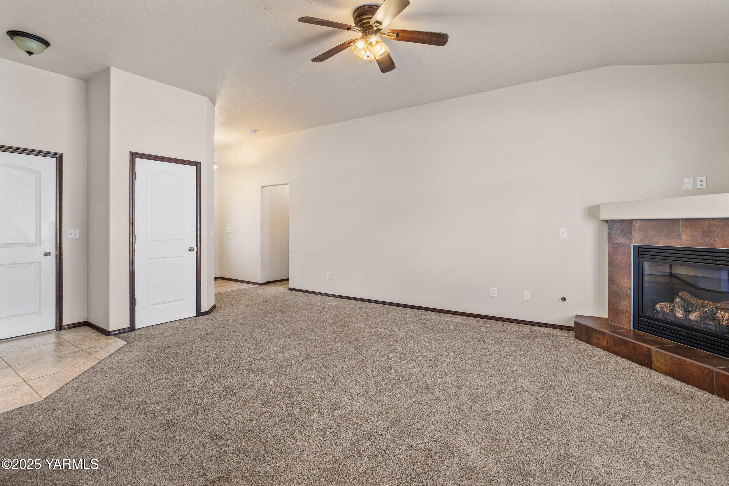2017 South 59th Avenue Yakima, WA 98903 - Photo 9 of 32 a view of an empty room with chandelier fan and fire place