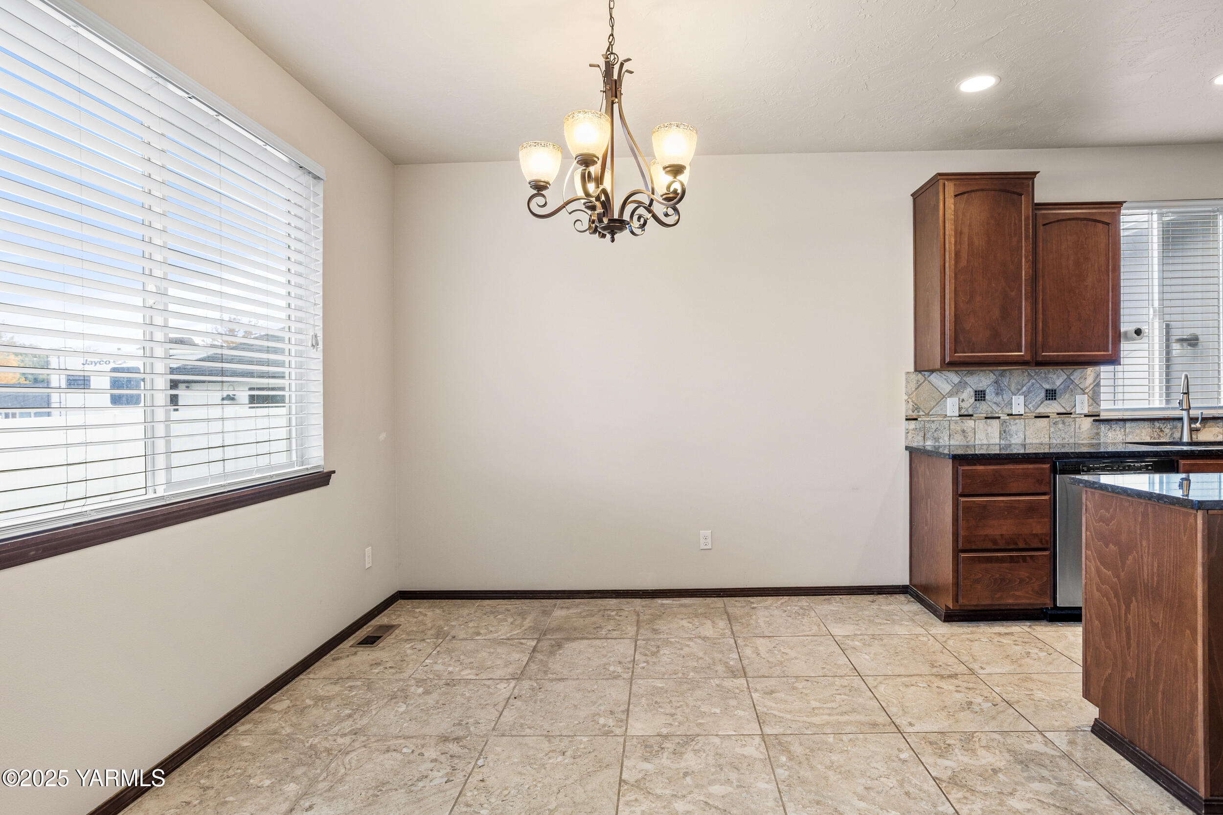 2017 South 59th Avenue Yakima, WA 98903 - Photo 10 of 32 a view of kitchen with granite countertop cabinets and window
