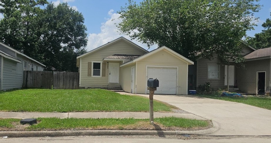 11919 Kingslake Forest Drive Houston, TX 77044 - Photo 1 of 12 a front view of house with yard and green space