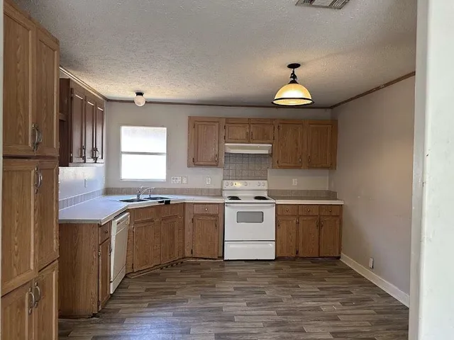 a kitchen with a stove top oven sink and cabinets