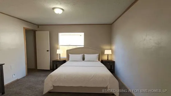 a bedroom with a bed and window