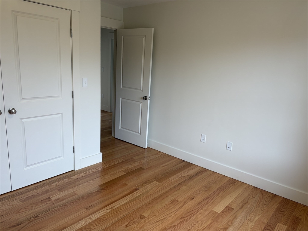 76 Valmor Street Worcester, MA 01604 - Photo 13 of 20 a view of an empty room with wooden floor
