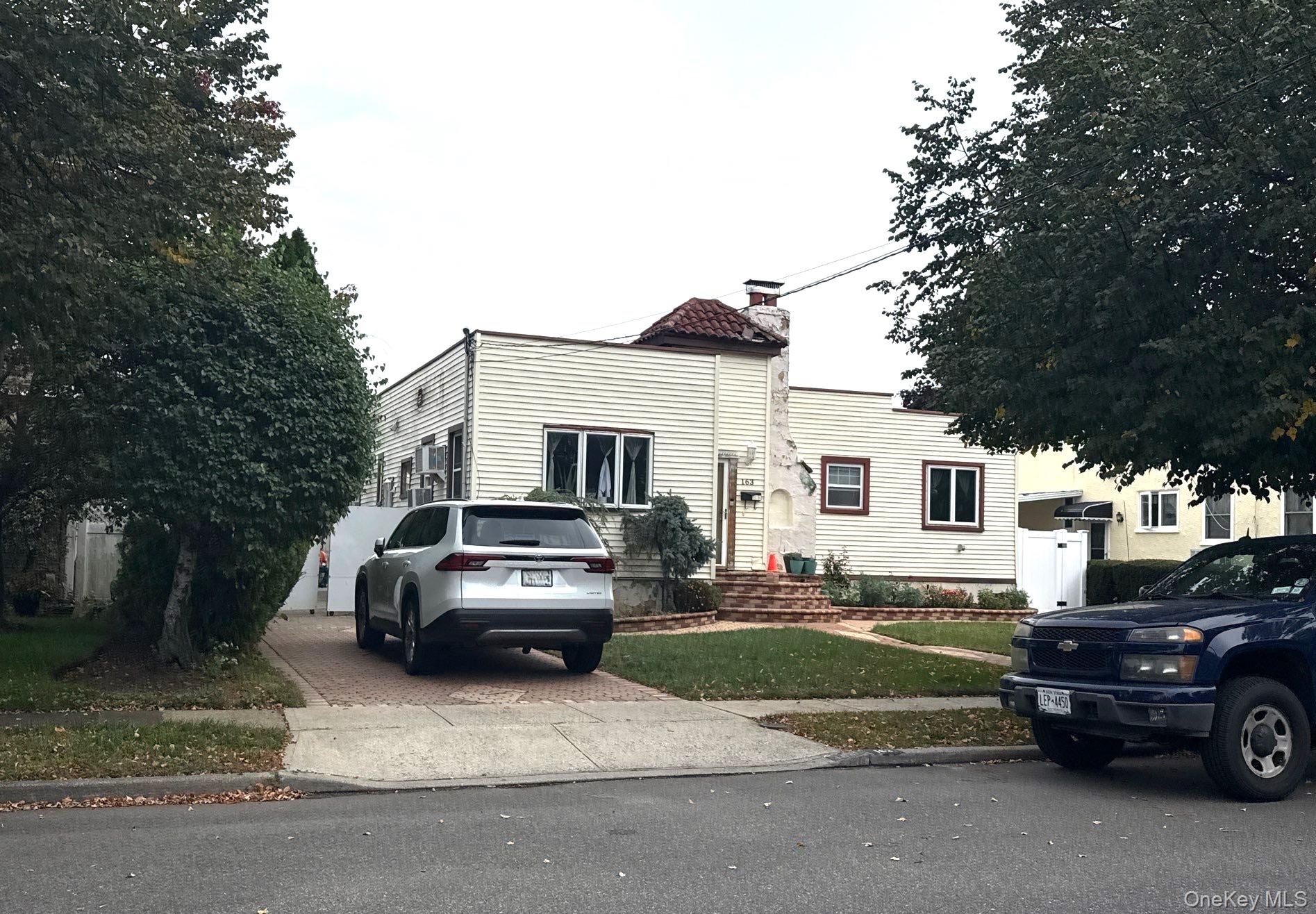 163 Wynsum Avenue Merrick, NY 11566 - Photo 3 of 3 a view of a car parked in front of a house