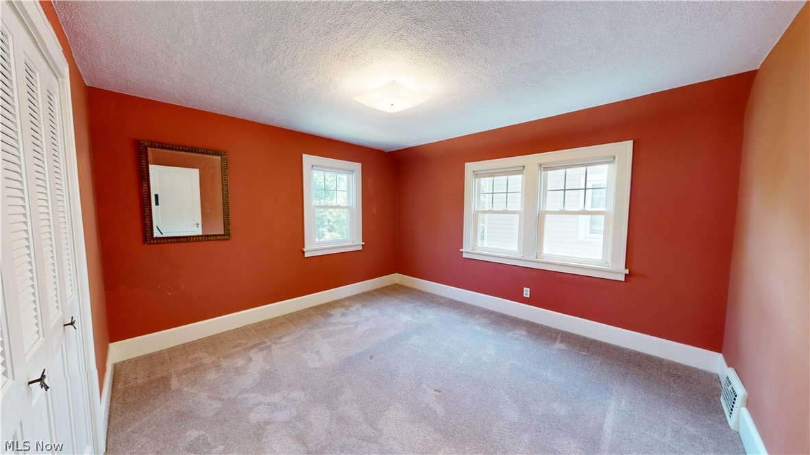 3988 Navahoe Road Cleveland Heights, OH 44121 - Photo 18 of 31 Unfurnished bedroom with carpet and a textured ceiling
