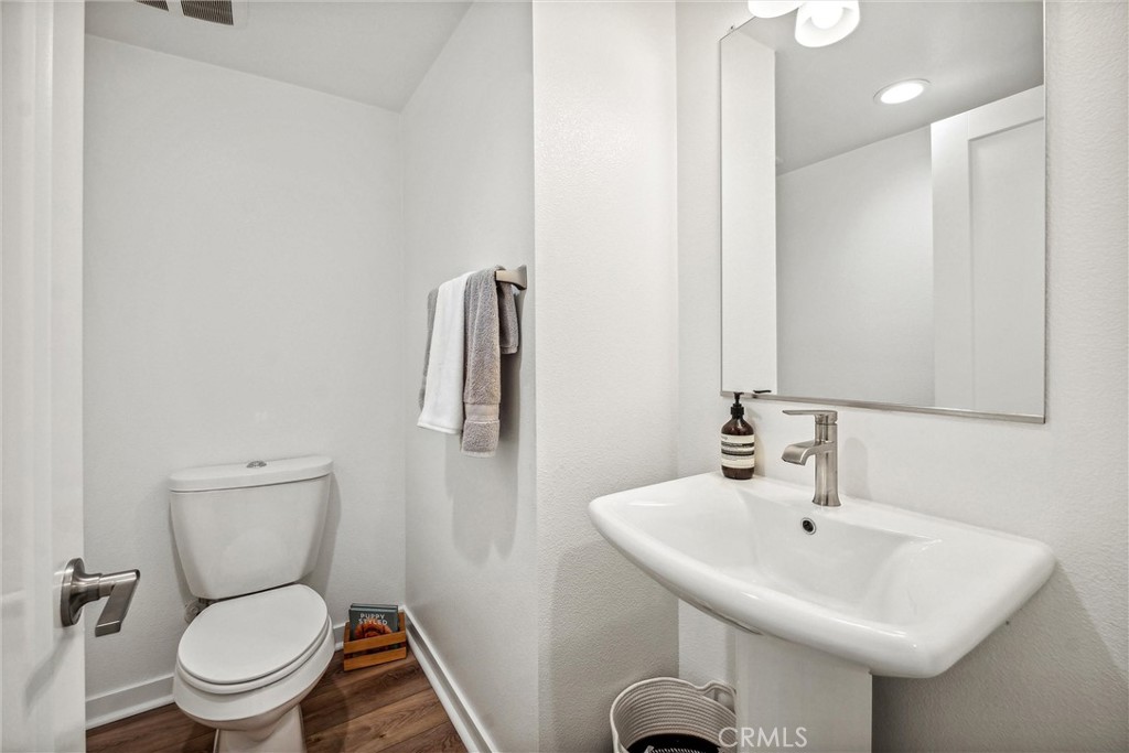 318 Ford Road Costa Mesa, CA 92627 - Photo 11 of 20 a bathroom with a toilet sink and mirror