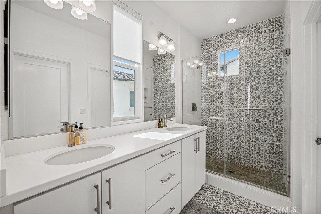 318 Ford Road Costa Mesa, CA 92627 - Photo 13 of 20 a bathroom with a shower sink and mirror