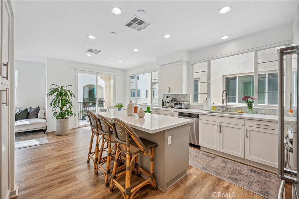 318 Ford Road Costa Mesa, CA 92627 - Photo 8 of 20 a kitchen with counter space dining table and chairs