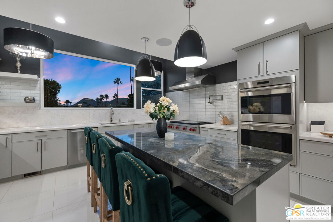 48365 Alan Circle Palm Desert, CA 92260 - Photo 12 of 75 a kitchen with stainless steel appliances granite countertop a sink a stove and cabinets