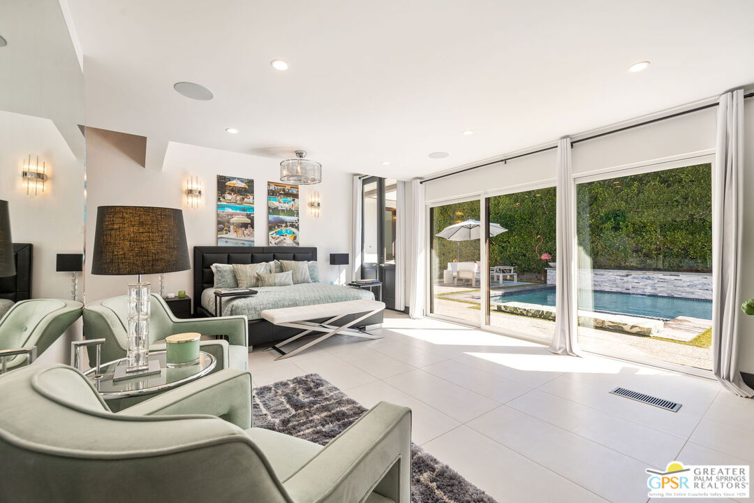 48365 Alan Circle Palm Desert, CA 92260 - Photo 13 of 75 a living room with furniture and a floor to ceiling window