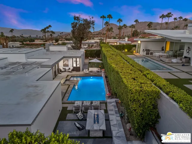 a living room with furniture a lamp and a rug