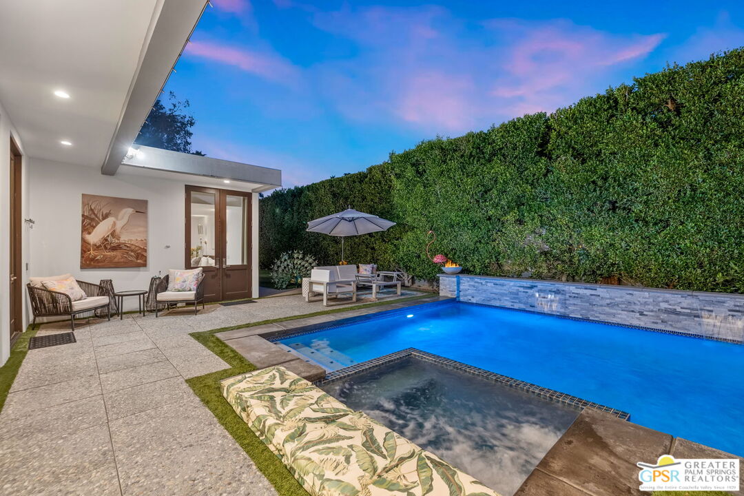 48365 Alan Circle Palm Desert, CA 92260 - Photo 23 of 75 a view of a swimming pool with an outdoor seating and a yard