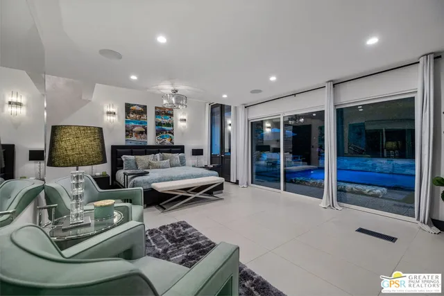 a living room with furniture and kitchen view