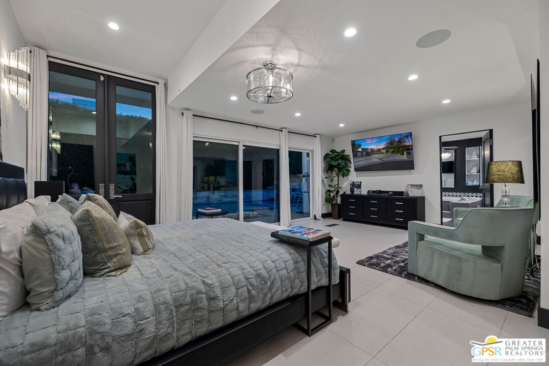 48365 Alan Circle Palm Desert, CA 92260 - Photo 27 of 75 a spacious bedroom with a bed and ceiling fan