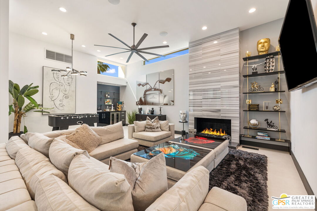 48365 Alan Circle Palm Desert, CA 92260 - Photo 3 of 75 a living room with furniture a fireplace and a flat screen tv