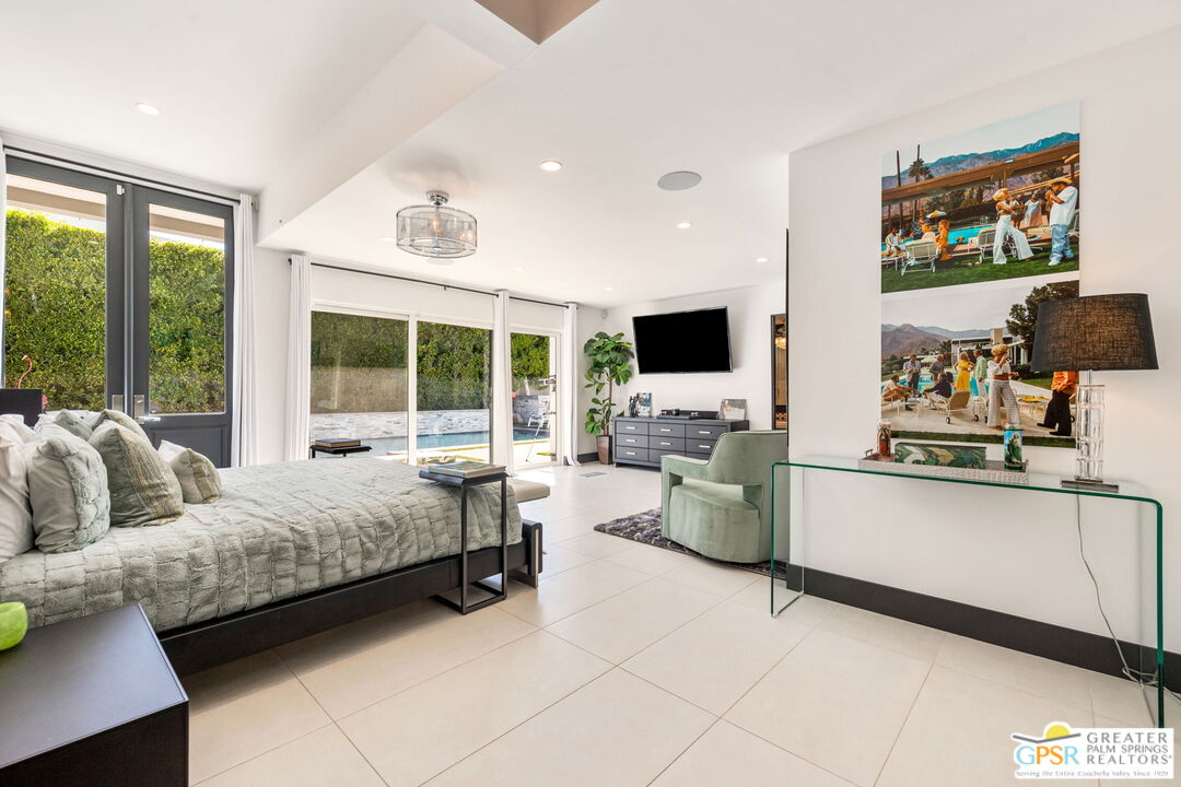 48365 Alan Circle Palm Desert, CA 92260 - Photo 35 of 75 a bedroom with furniture and a flat screen tv