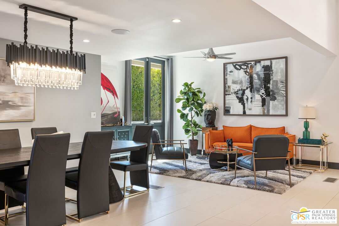 48365 Alan Circle Palm Desert, CA 92260 - Photo 40 of 75 a dining room with furniture a floor to ceiling window and outdoor kitchen view