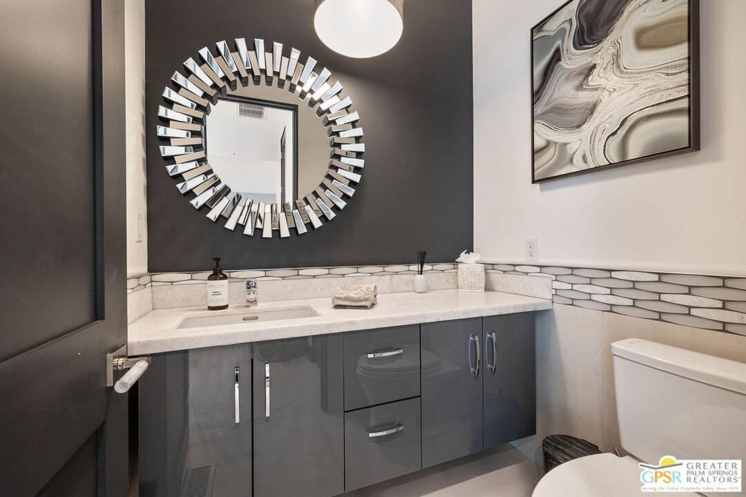 48365 Alan Circle Palm Desert, CA 92260 - Photo 42 of 75 a bathroom with a toilet sink and mirror