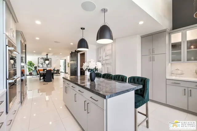 a view of a patio with furniture and a yard