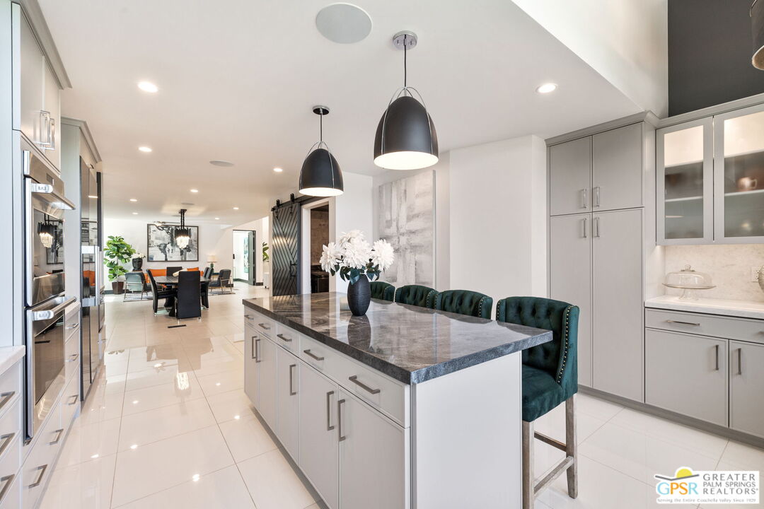 48365 Alan Circle Palm Desert, CA 92260 - Photo 45 of 75 a kitchen with granite countertop a sink a counter top space and living room view