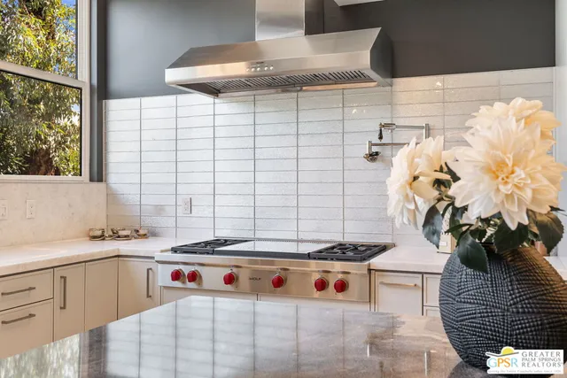 a kitchen with stainless steel appliances granite countertop a sink stove and microwave
