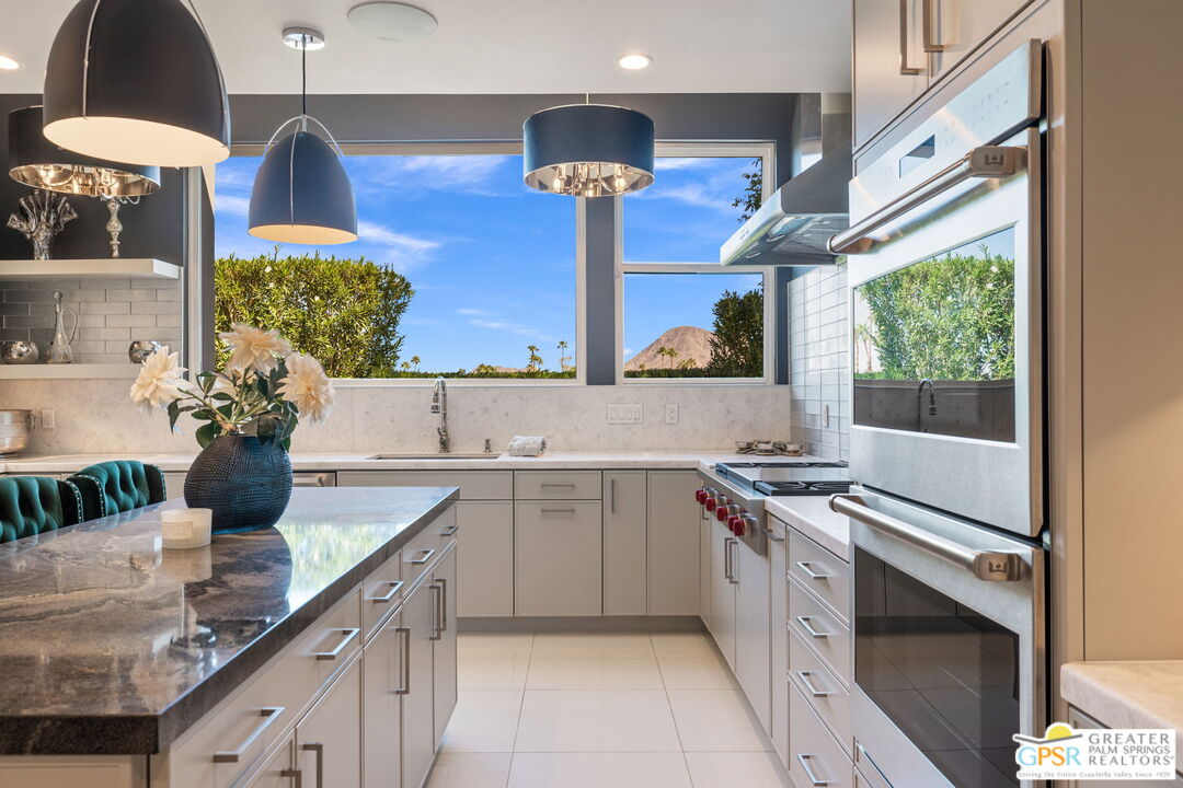 48365 Alan Circle Palm Desert, CA 92260 - Photo 49 of 75 a kitchen with stainless steel appliances a stove sink and cabinets