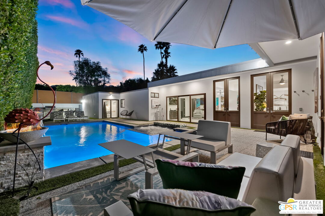 48365 Alan Circle Palm Desert, CA 92260 - Photo 5 of 75 a living room with furniture a chandelier and a table