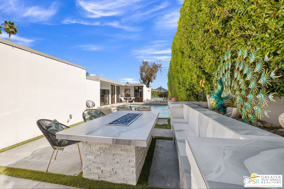 48365 Alan Circle Palm Desert, CA 92260 - Photo 60 of 75 a view of a patio with table and chairs and potted plants