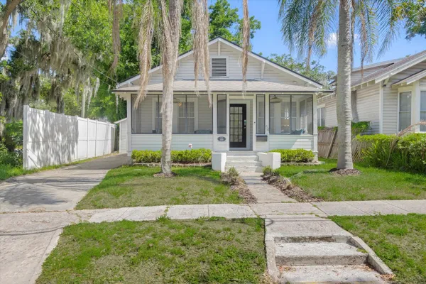 a front view of a house with a yard and porch