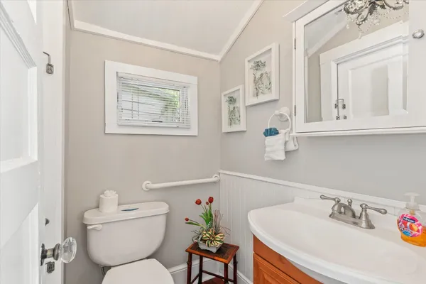 a bathroom with a toilet sink and mirror