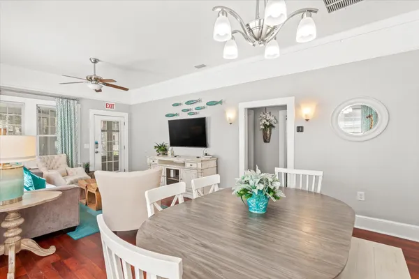 a view of a dining room with furniture and wooden floor
