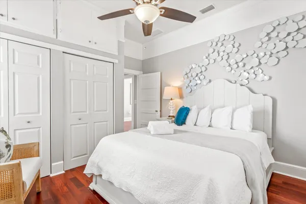 a bedroom with a large bed and a chandelier
