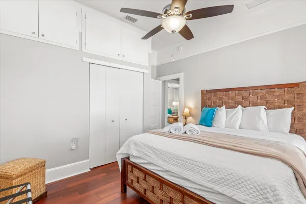 a bedroom with a large bed and a chandelier