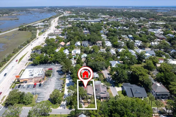 an aerial view of a house with garden space and street view
