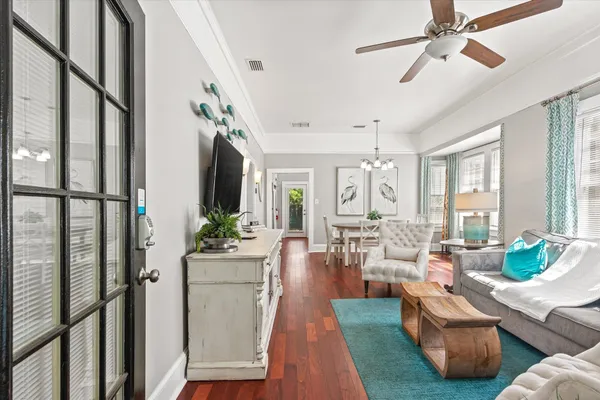 a living room with furniture and wooden floor