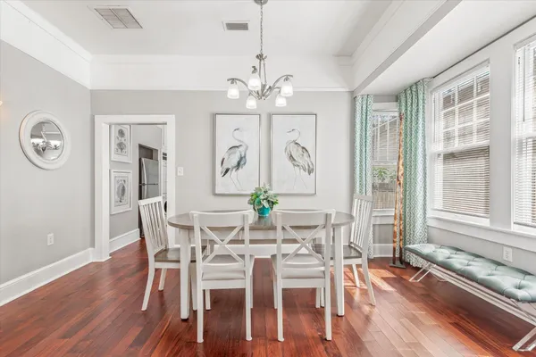 a view of a dining room with furniture window and wooden floor