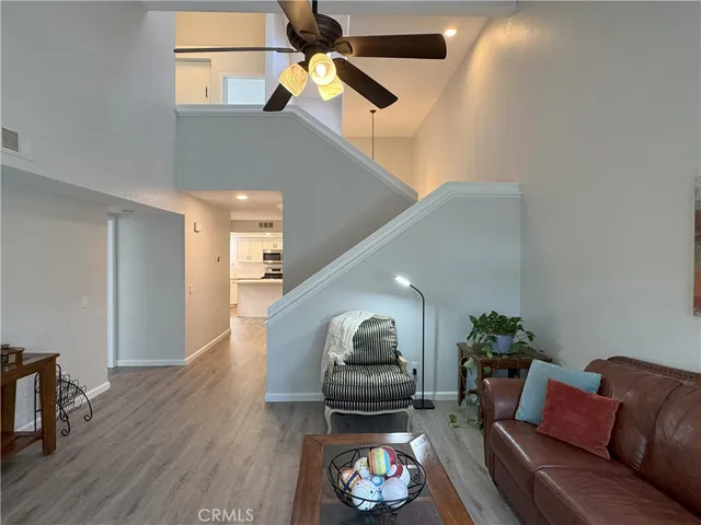 a living room with furniture and a potted plant