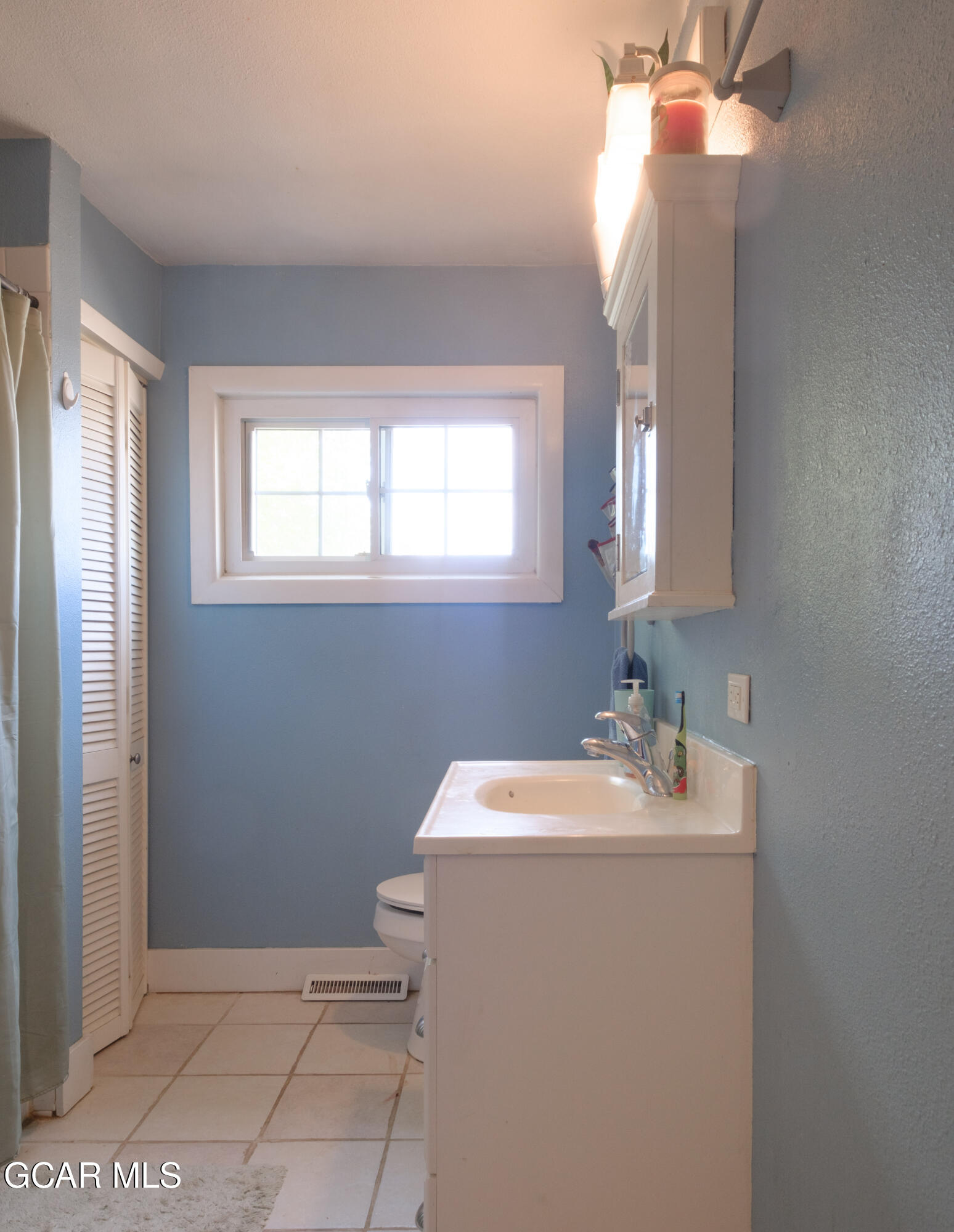 404 5th Street Kremmling, CO 80459 - Photo 17 of 56 a bathroom with a sink a vanity and a mirror