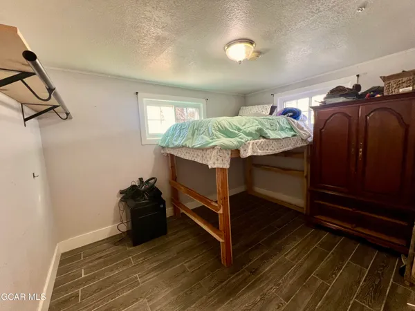 a bedroom with a bed and flat screen tv