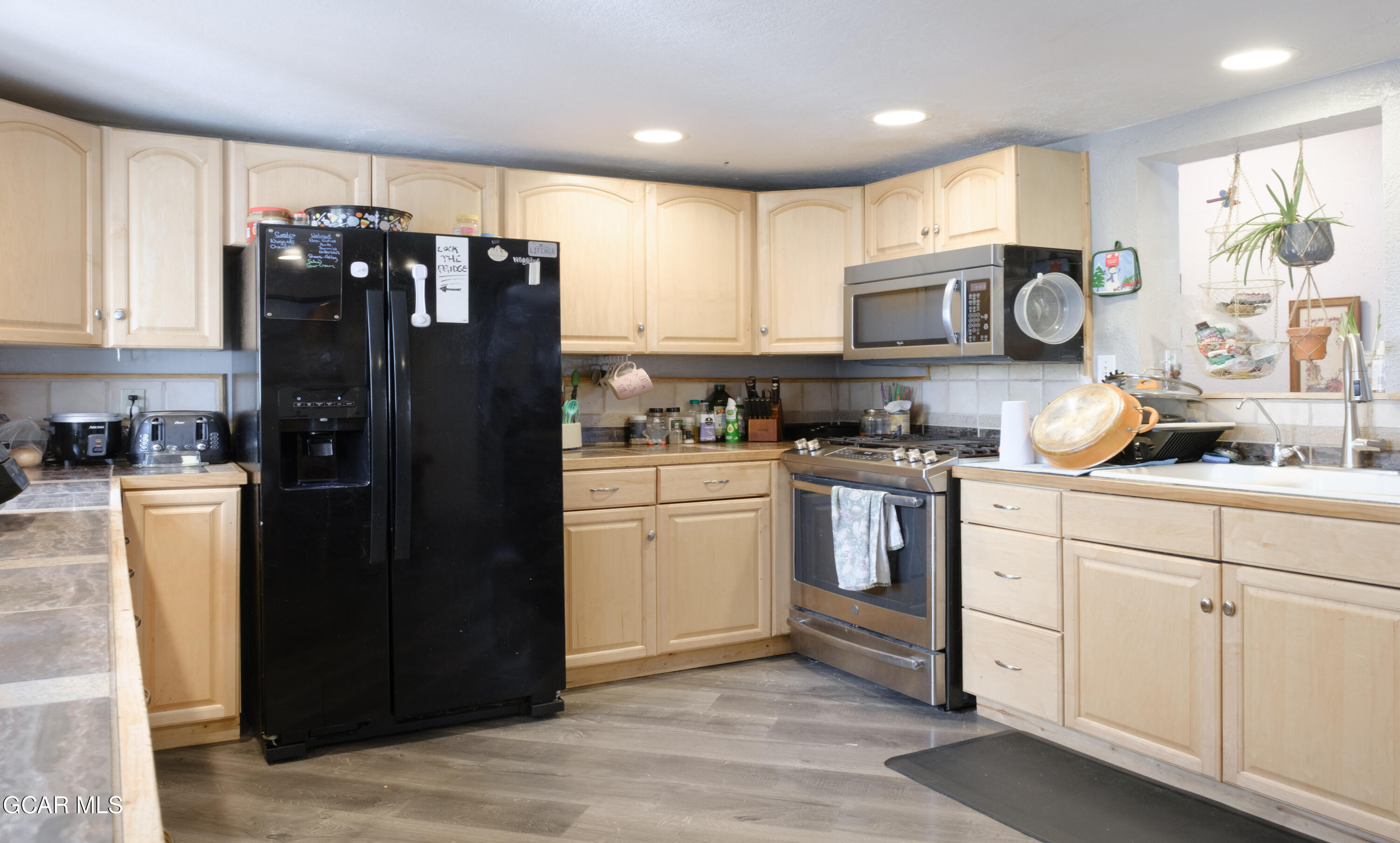 404 5th Street Kremmling, CO 80459 - Photo 9 of 56 a kitchen with a refrigerator and cabinets